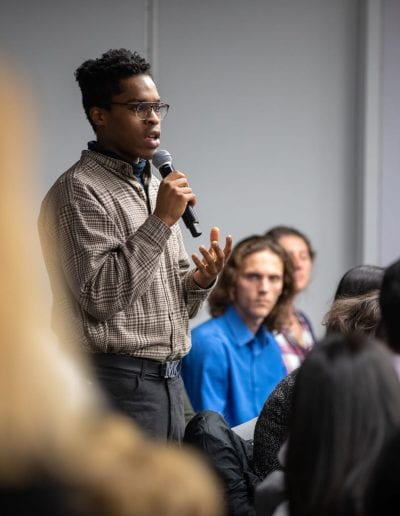 Student asking question at How Women Saved Rwanda event
