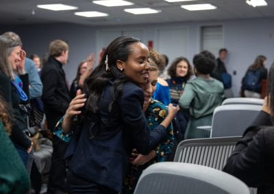Two women hug at How Women Saved Rwanda event