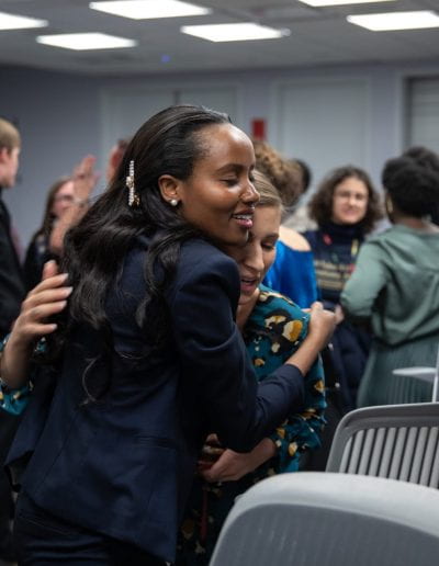 Two women hug at How Women Saved Rwanda event